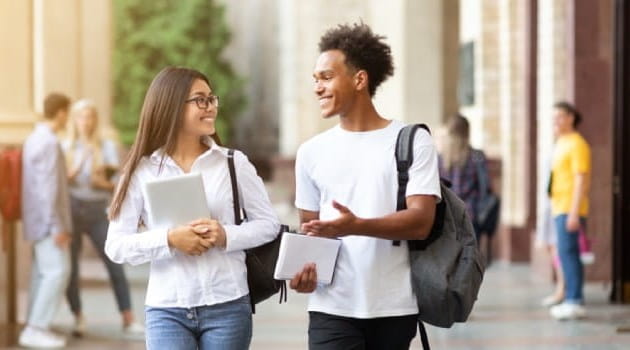 Two students walking through campus