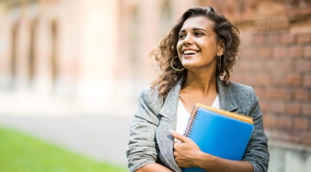 Young woman in grey blazer holding folders