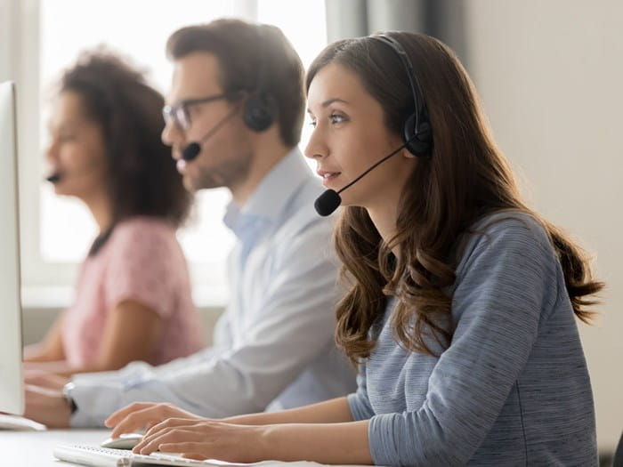Advisors wearing headsets answering phone calls