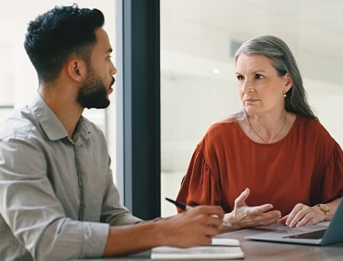 colleagues manager employee having a serious meeting in an office meeting room
