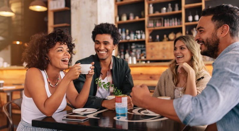 Diverse black and white young business people laughing and smiling together.