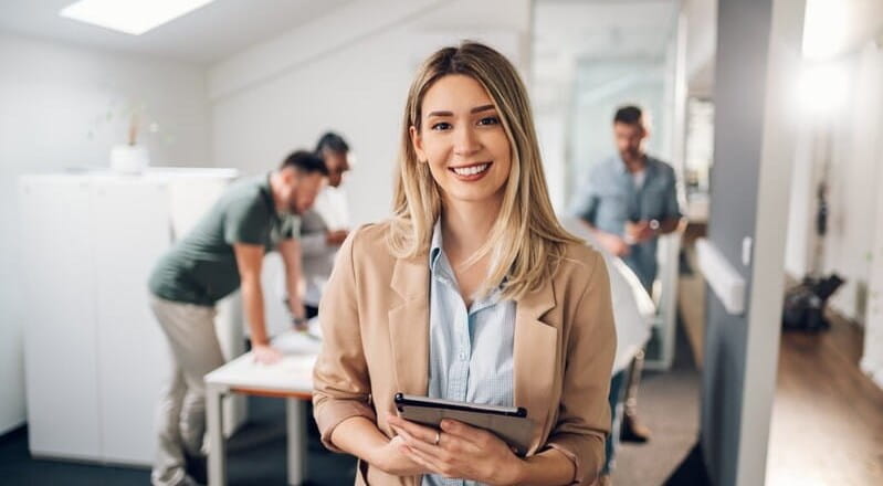 Image of a woman smiling and a focus on leadership.