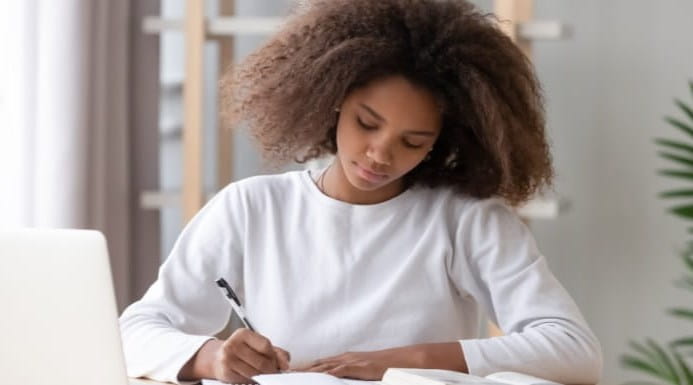 Student studying with books and laptop