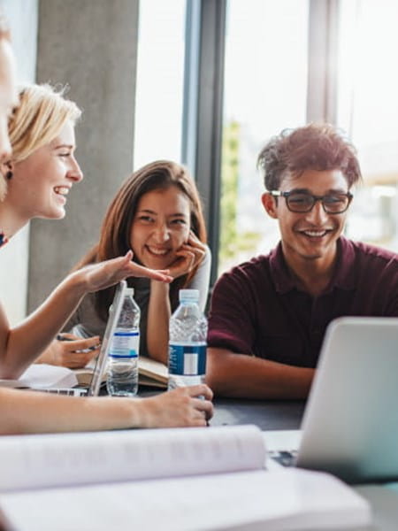 Group of people sat round laptop