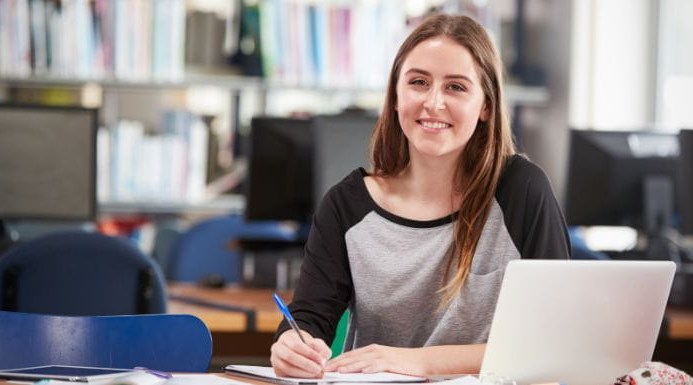 Image of young woman working at a laptop