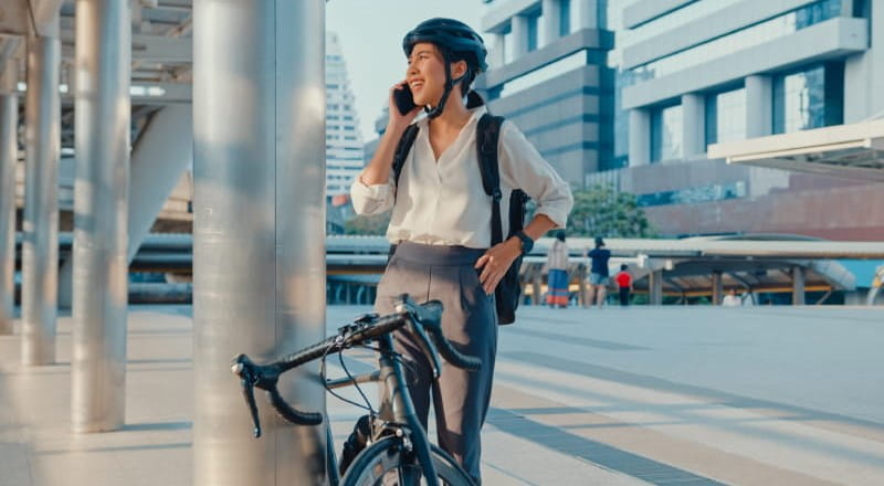Young woman cycling to work in city
