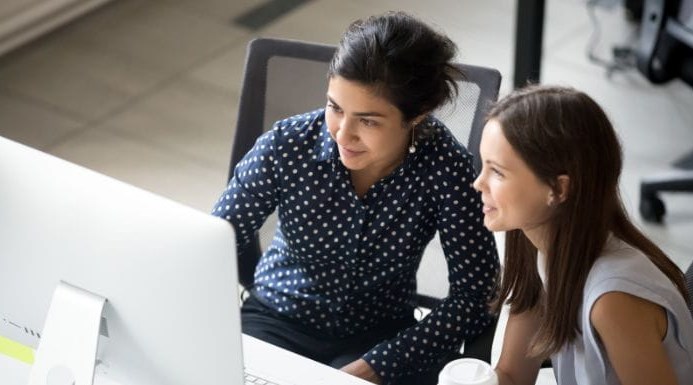 Two people sat at a desk