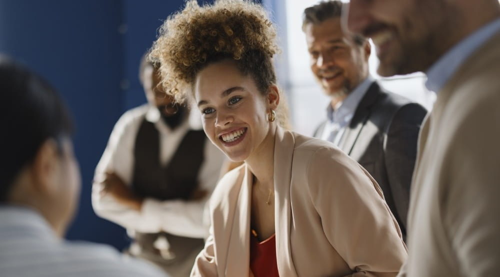 Woman smiling at her colleagues