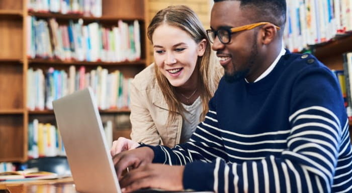 Two people working on laptop