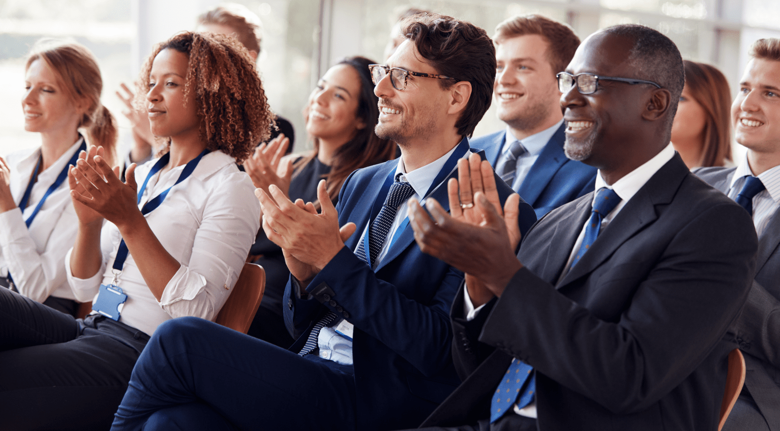 Audience of professional people applauding a speaker