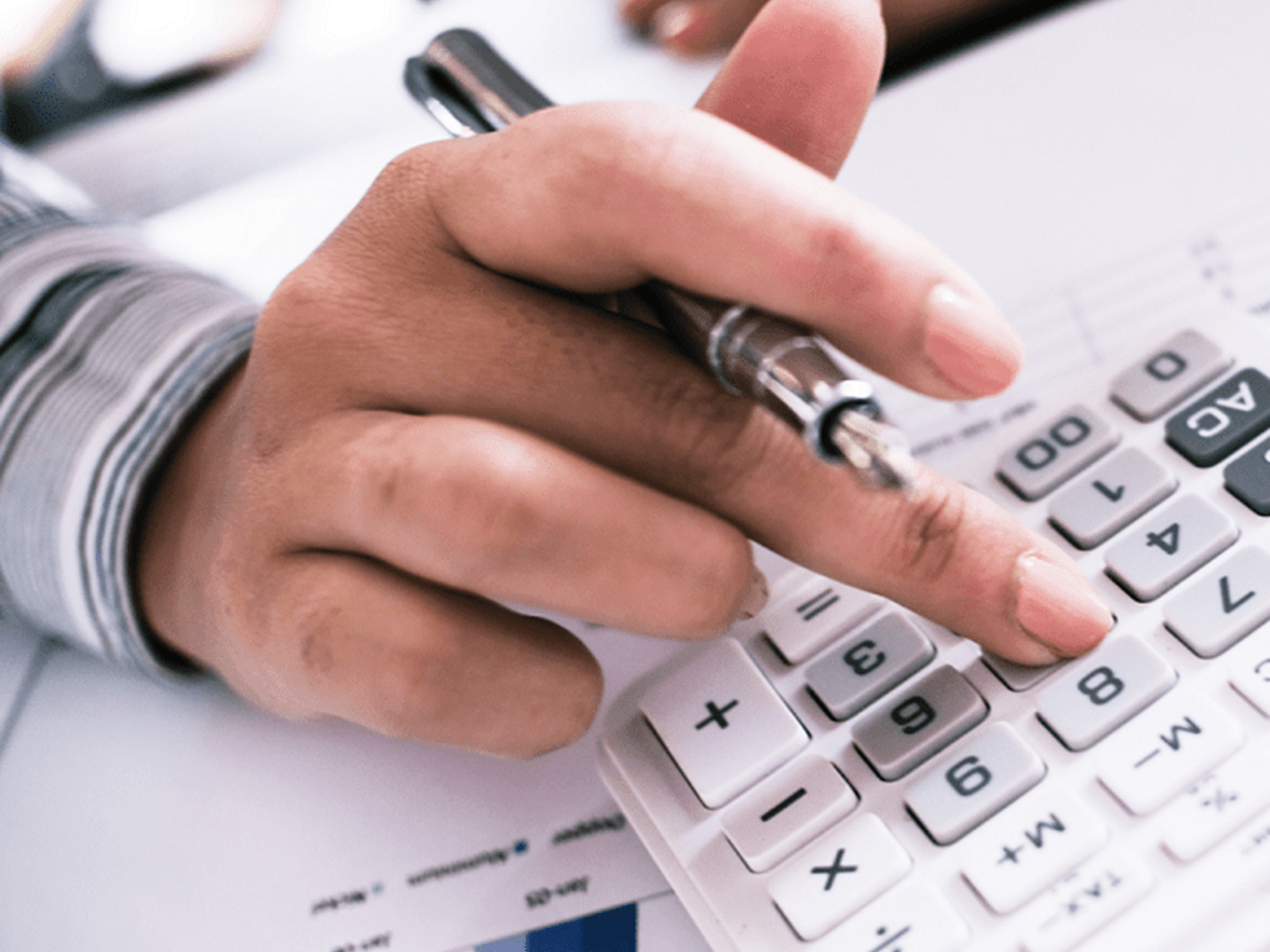Closeup of a hand using a calculator