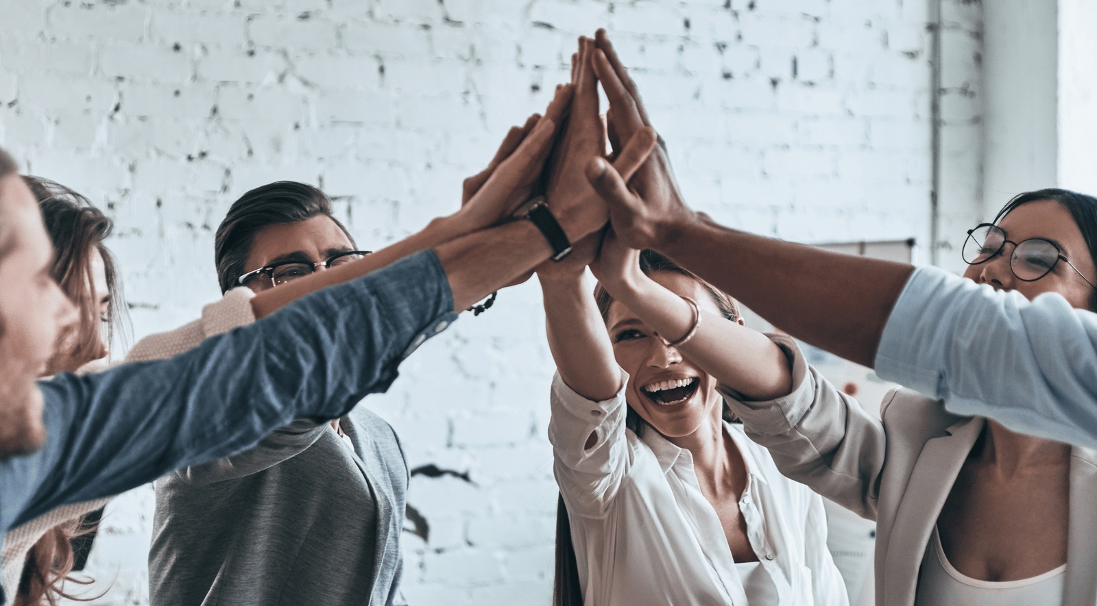 Young people in a group high five