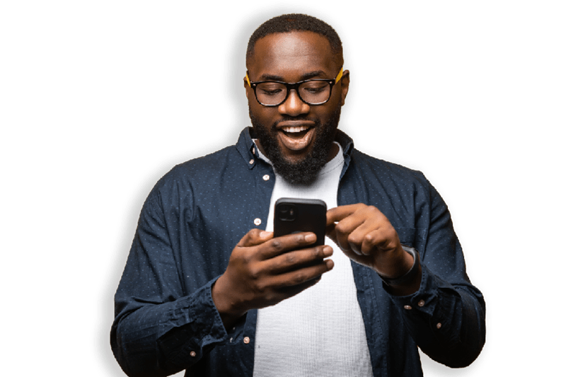 Man smiling as he uses his smartphone