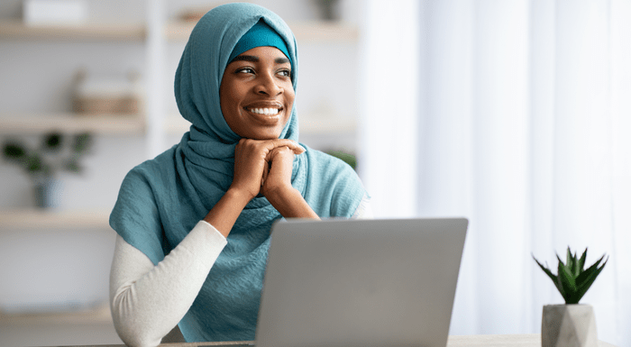 Person sat at a desk smiling