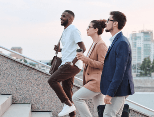 Three people walking up the stairs