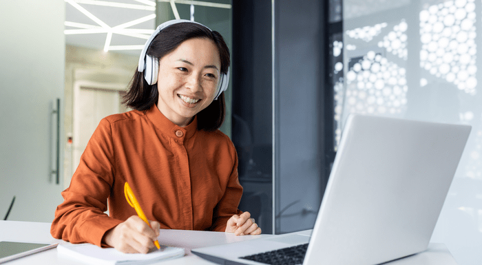 Smiling woman on laptop video meeting